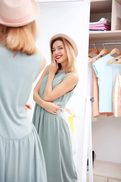 Young woman looking into mirror — Stock Photo, Image