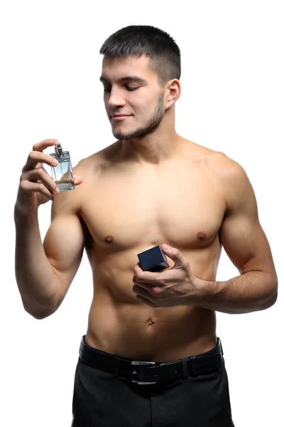 Hombre guapo con botella de perfume sobre fondo blanco —  Fotos de Stock