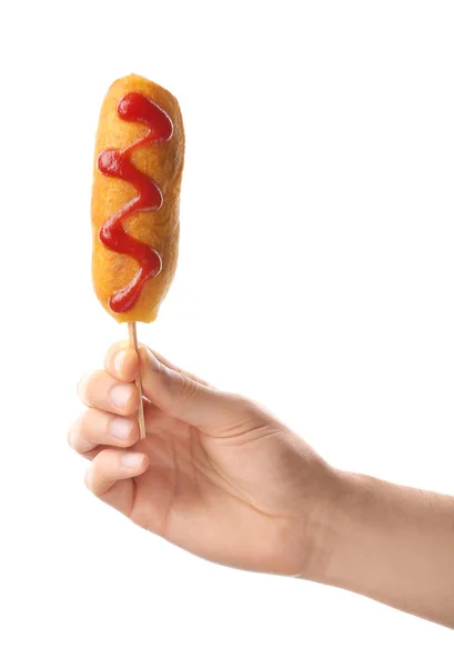 Woman holding tasty corn dog — Stock Photo, Image