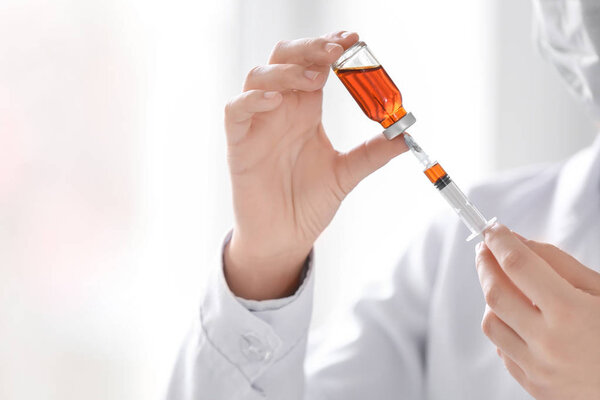 Doctor holding syringe