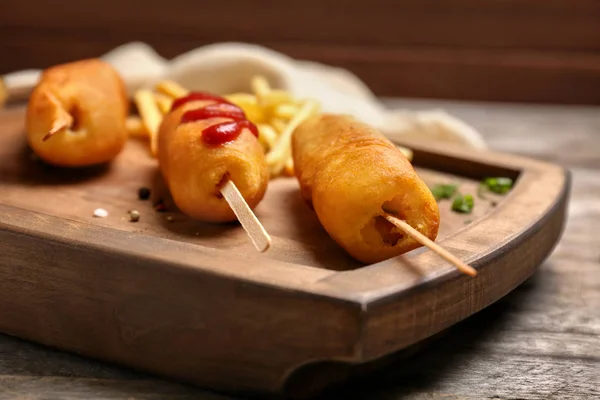 Tasty corn dogs with ketchup — Stock Photo, Image