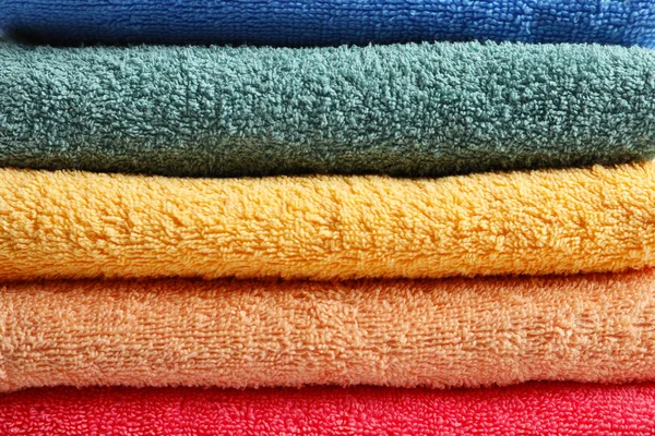 Stack of clean colorful terry towels, closeup — Stock Photo, Image