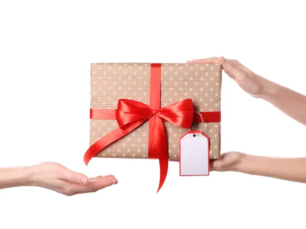 Woman receiving gift box from her friend on white background — Stock Photo, Image