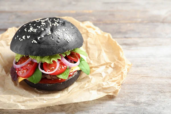 Tasty burger with black bun