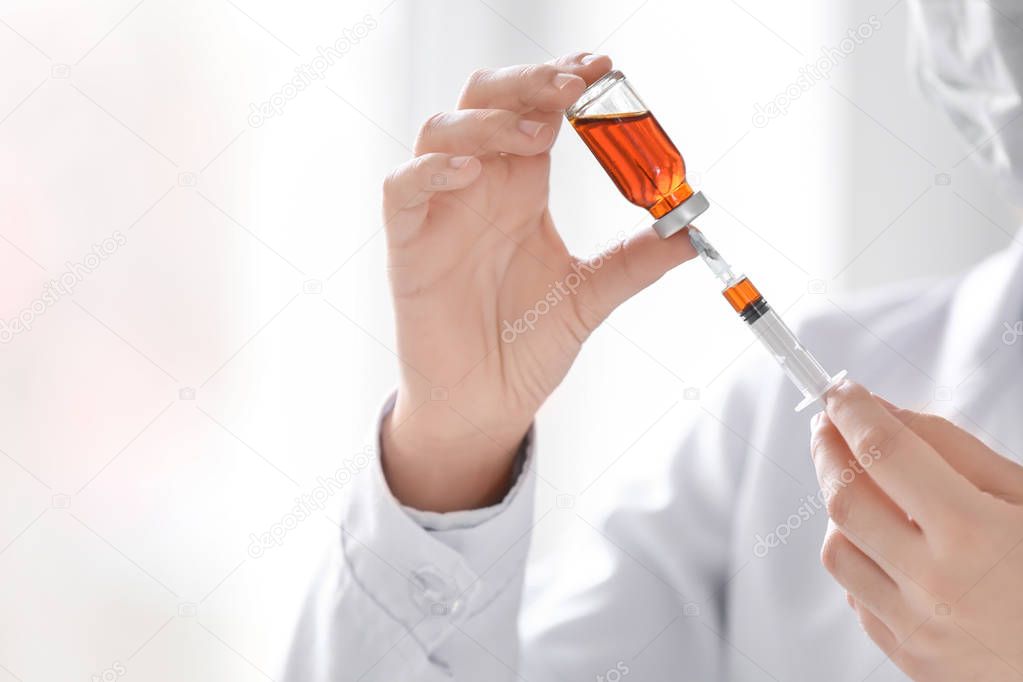 Doctor holding syringe