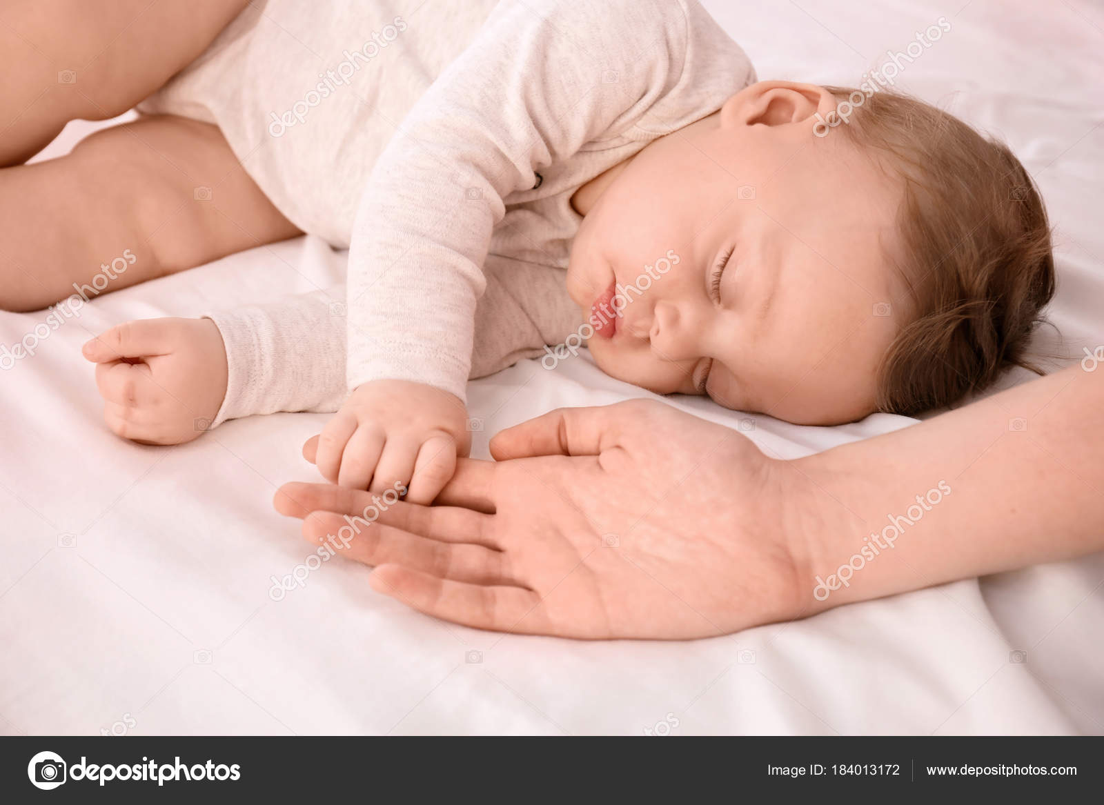 baby holding bed
