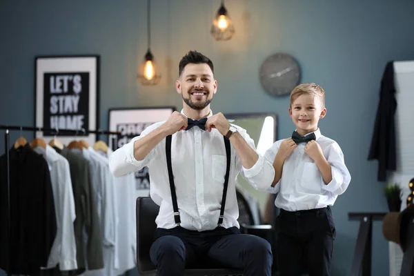 Father and son in elegant suits, indoors