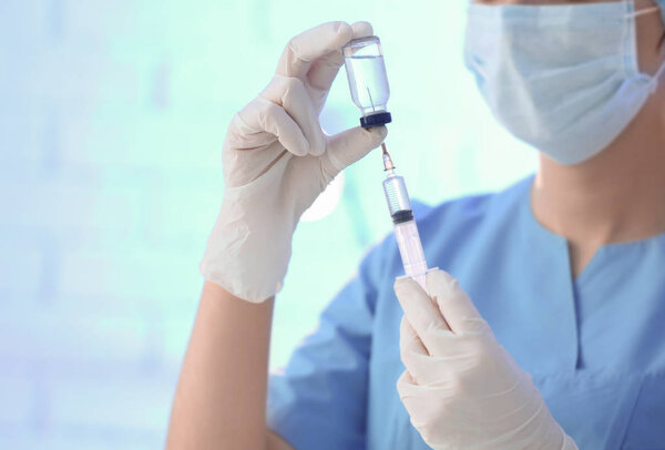 Doctor holding syringe