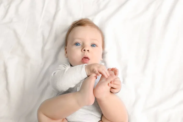 Cute little baby lying on bed, top view — Stock Photo, Image