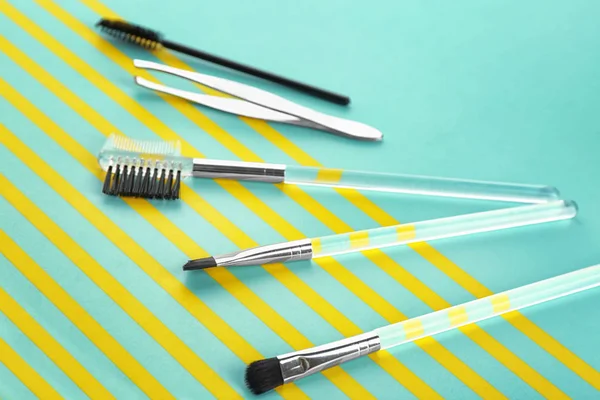 Set of tools for eyebrow dyeing and correction on color background