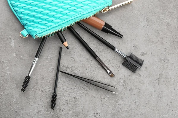 Set of tools for eyebrow dyeing and correction on grey background