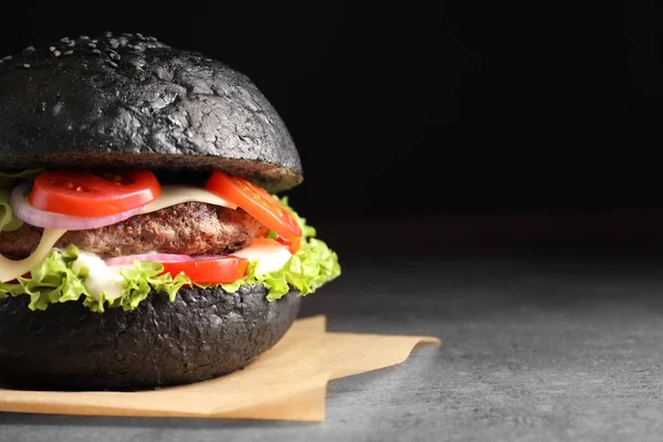 Tasty burger with black bun