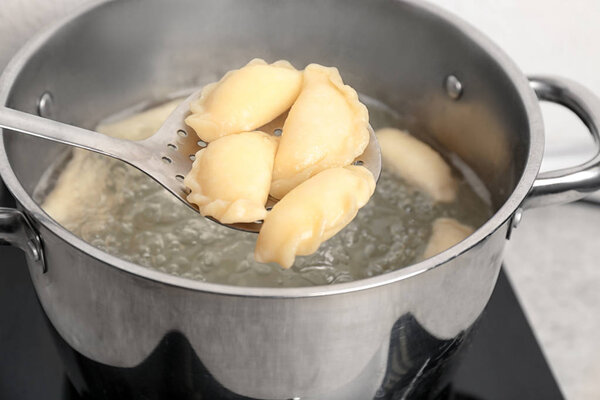 Cooking dumplings in boiling water, closeup