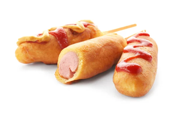 Tasty corn dog with ketchup and mustard on white background — Stock Photo, Image