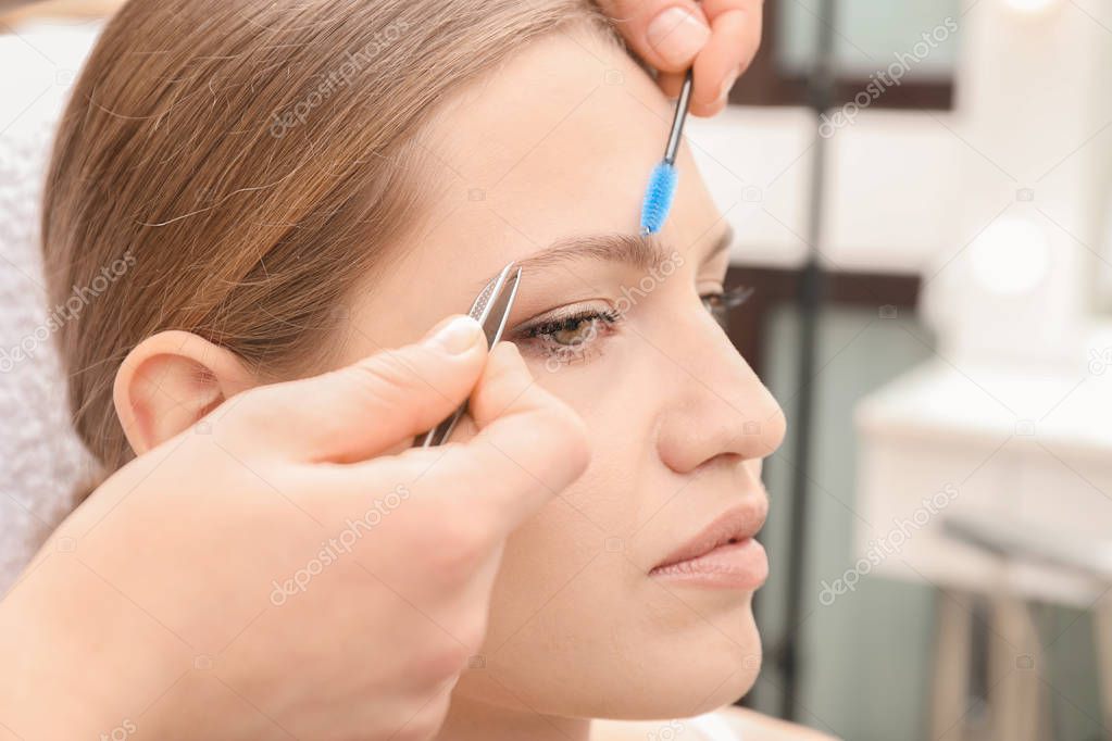 woman undergoing eyebrow correction procedure 