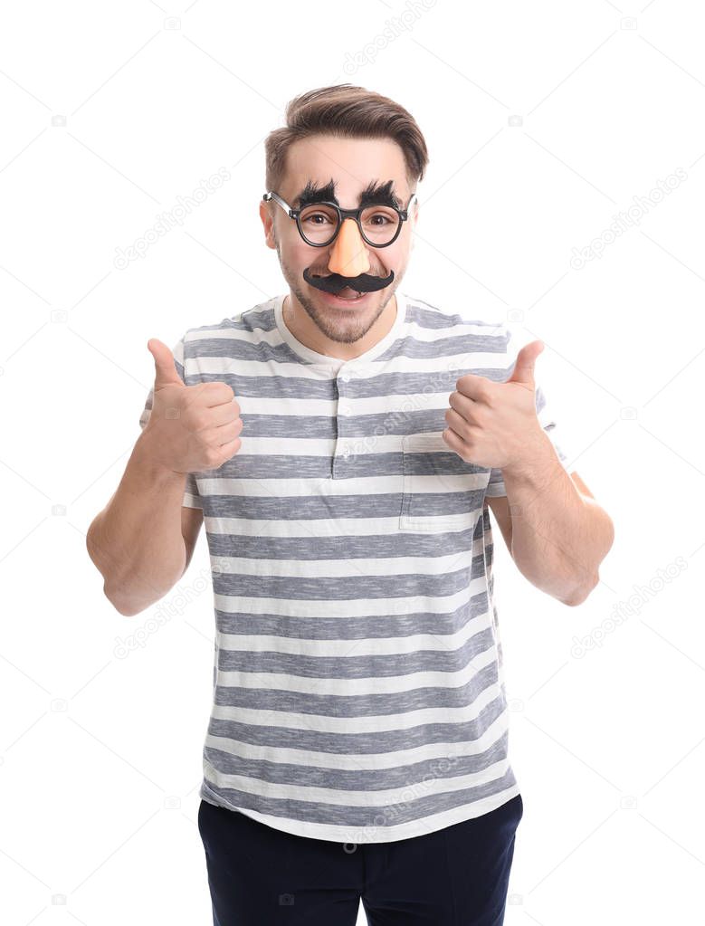 Young man in funny glasses on white background. April fool's day celebration