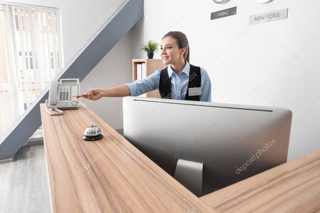 Female receptionist with card in hotel