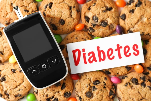 Cartão com palavra "Diabetes" e glicosímetro digital em cookies — Fotografia de Stock