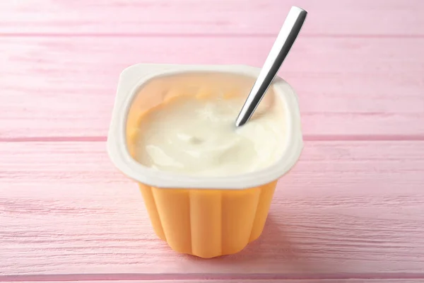 Plastic cup with yummy yogurt — Stock Photo, Image
