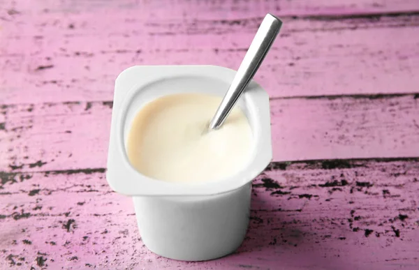 Plastic cup with yummy yogurt — Stock Photo, Image