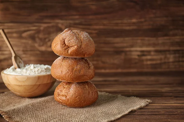 Tasty buns on wooden background — Stock Photo, Image