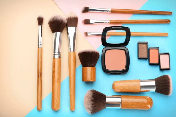 Decorative cosmetics and tools of professional makeup artist on color background — Stock Photo, Image