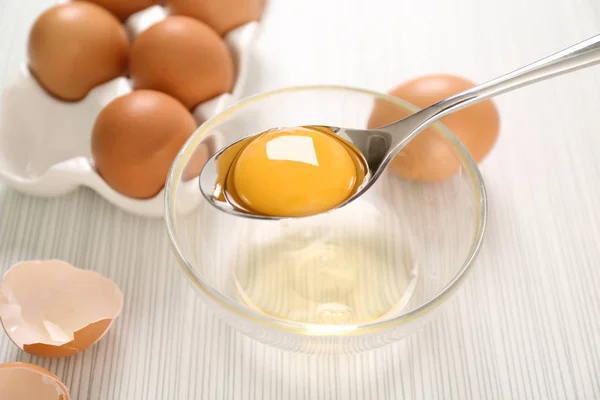 Spoon with egg yolk — Stock Photo, Image