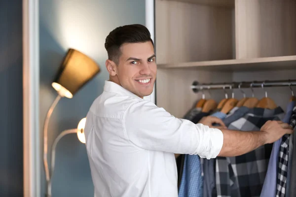 Man picking shirt from closet. — Stock Photo, Image