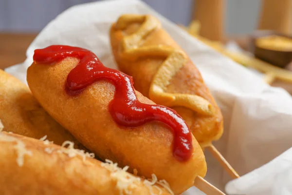 Tasty corn dogs with sauces, closeup — Stock Photo, Image