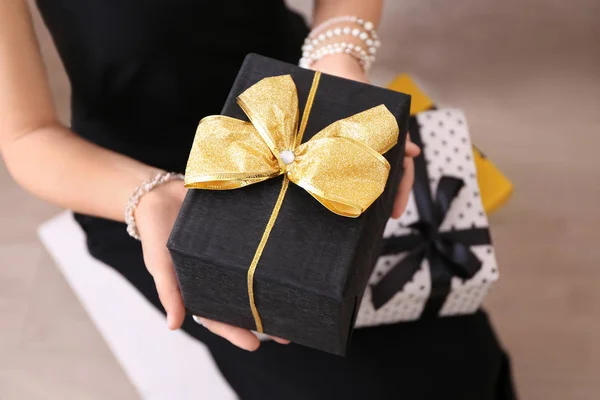 Young woman holding gift boxes — Stock Photo, Image