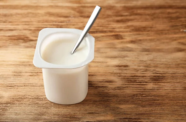 Plastic cup with yummy yogurt — Stock Photo, Image