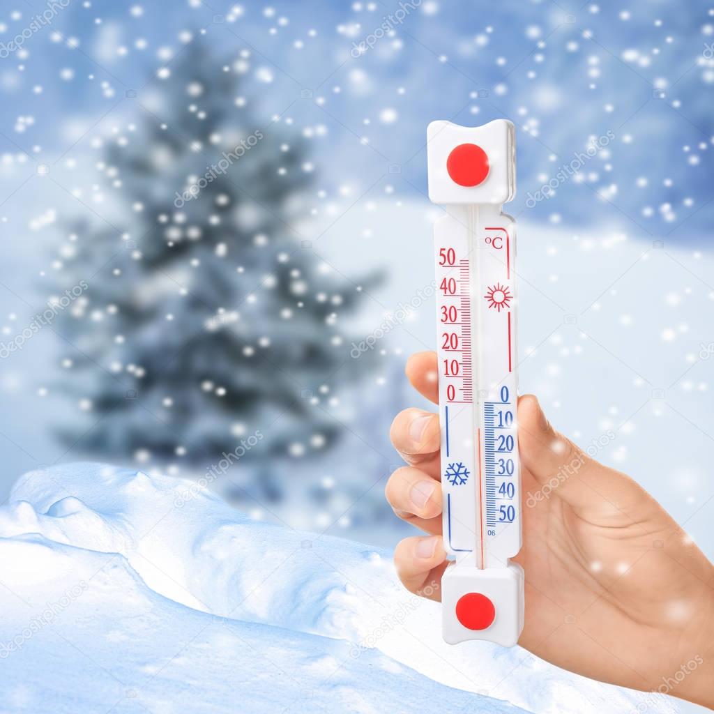Woman with thermometer registering temperature 