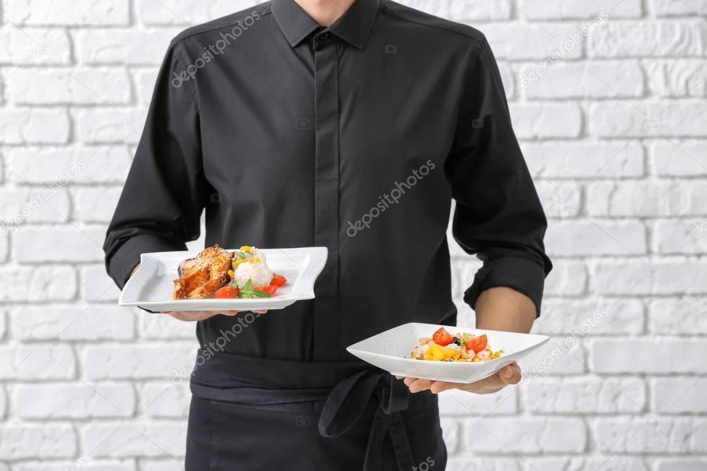 Waiter holding plates