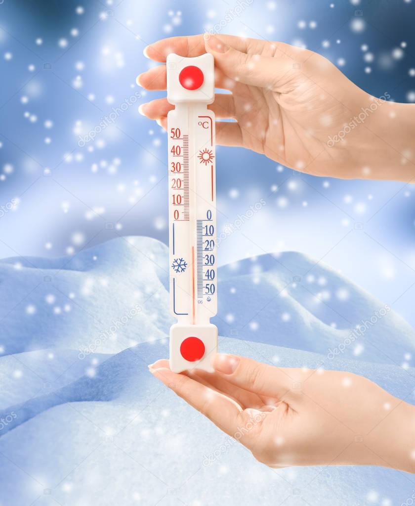 Woman with thermometer registering temperature 