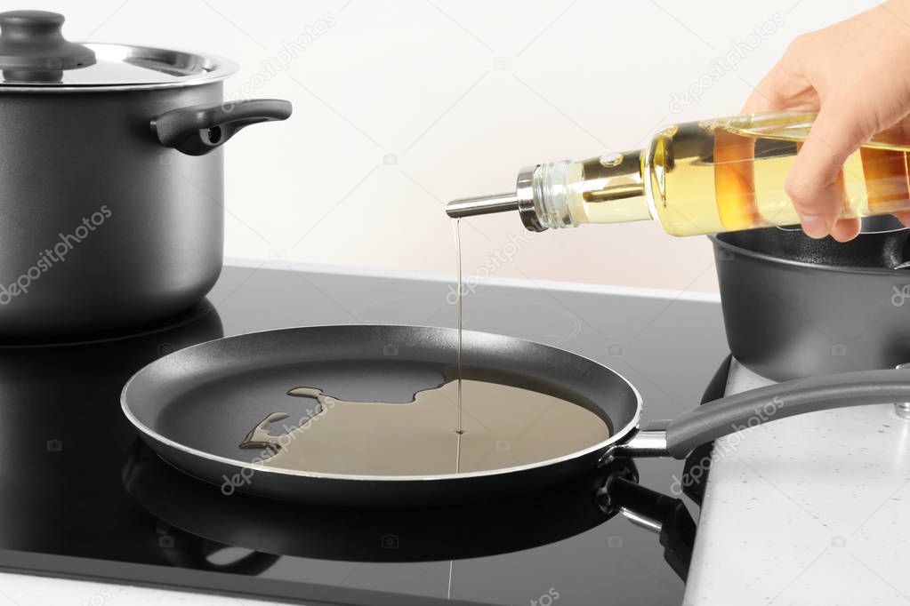 Woman pouring cooking oil