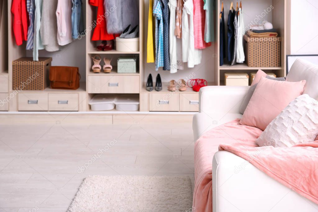 Cozy sofa and big wardrobe in dressing room