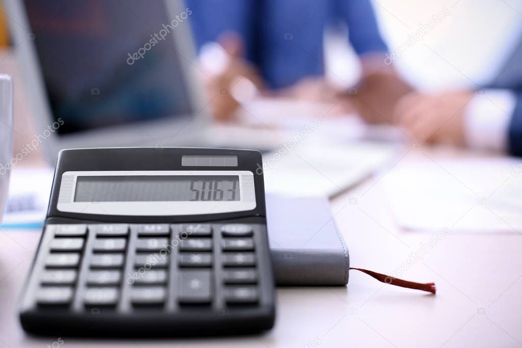 Calculator on table in office. Financial trading concept