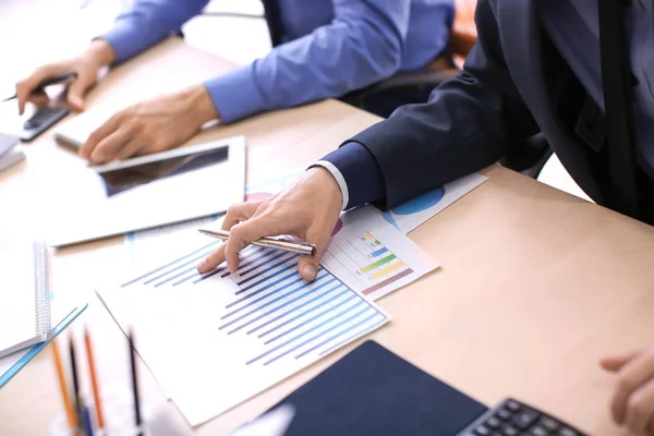 Men working at table in office, closeup. Financial trading concept — Stock Photo, Image