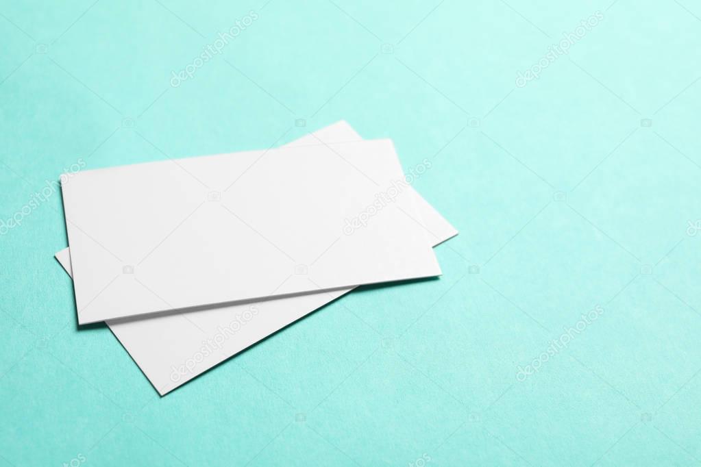 Blank business cards on color background