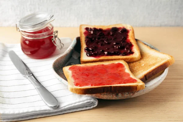 Delicious toasts with sweet jams on table — Stock Photo, Image