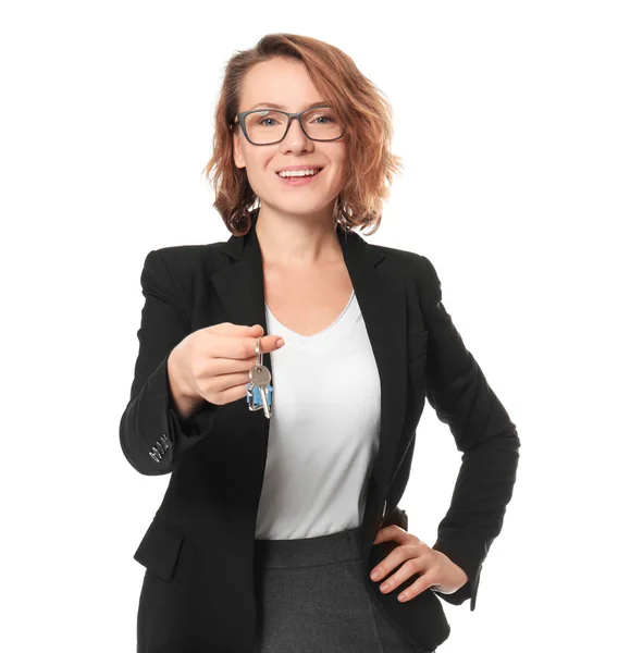 Beautiful real estate agent with key on white background — Stock Photo, Image