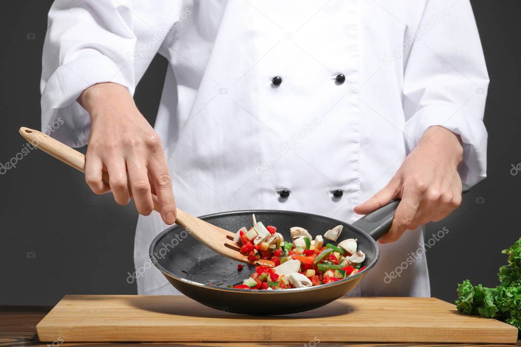 Female chef in uniform cooking, closeup