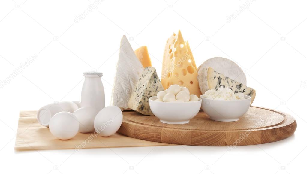 Different dairy products and eggs on white background