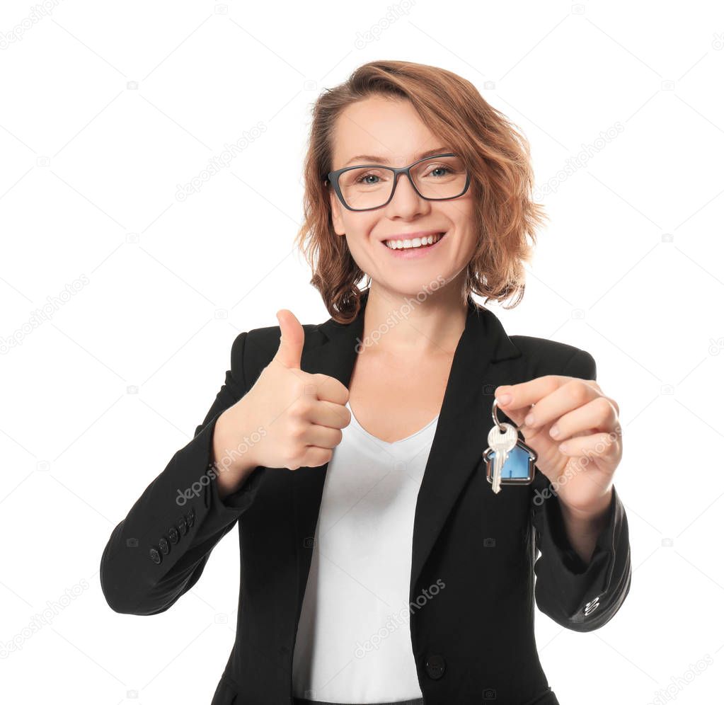 Beautiful real estate agent with key on white background