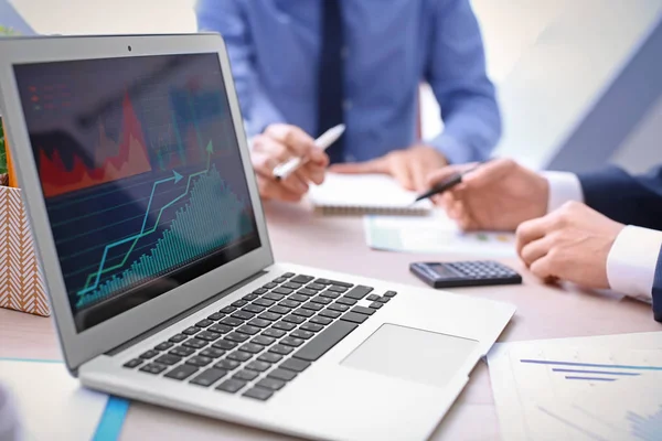 Laptop with stock data on table in office. Financial trading concept — Stock Photo, Image