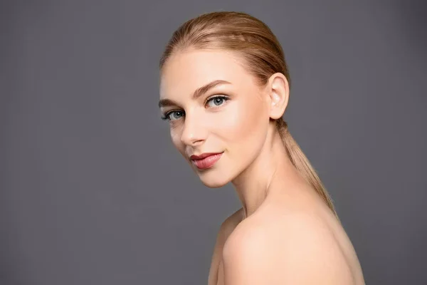 Portrait of beautiful young woman with clear skin on grey background — Stock Photo, Image