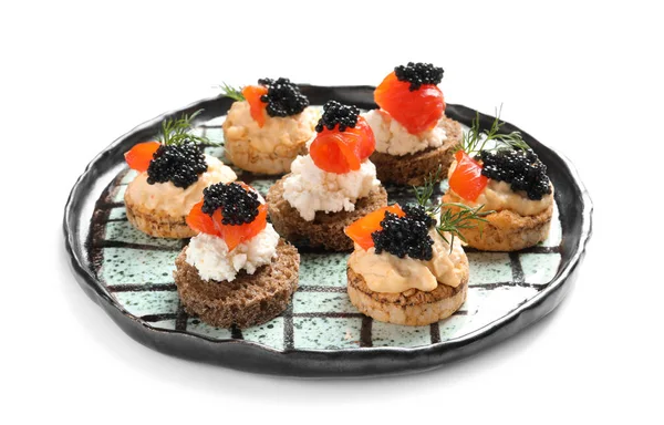 Teller mit leckeren Häppchen mit schwarzem Kaviar auf weißem Hintergrund — Stockfoto