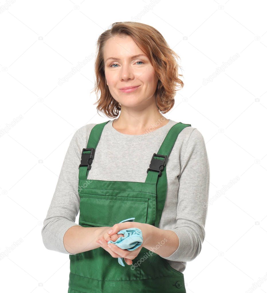 Female auto mechanic wiping hands with rag on white background