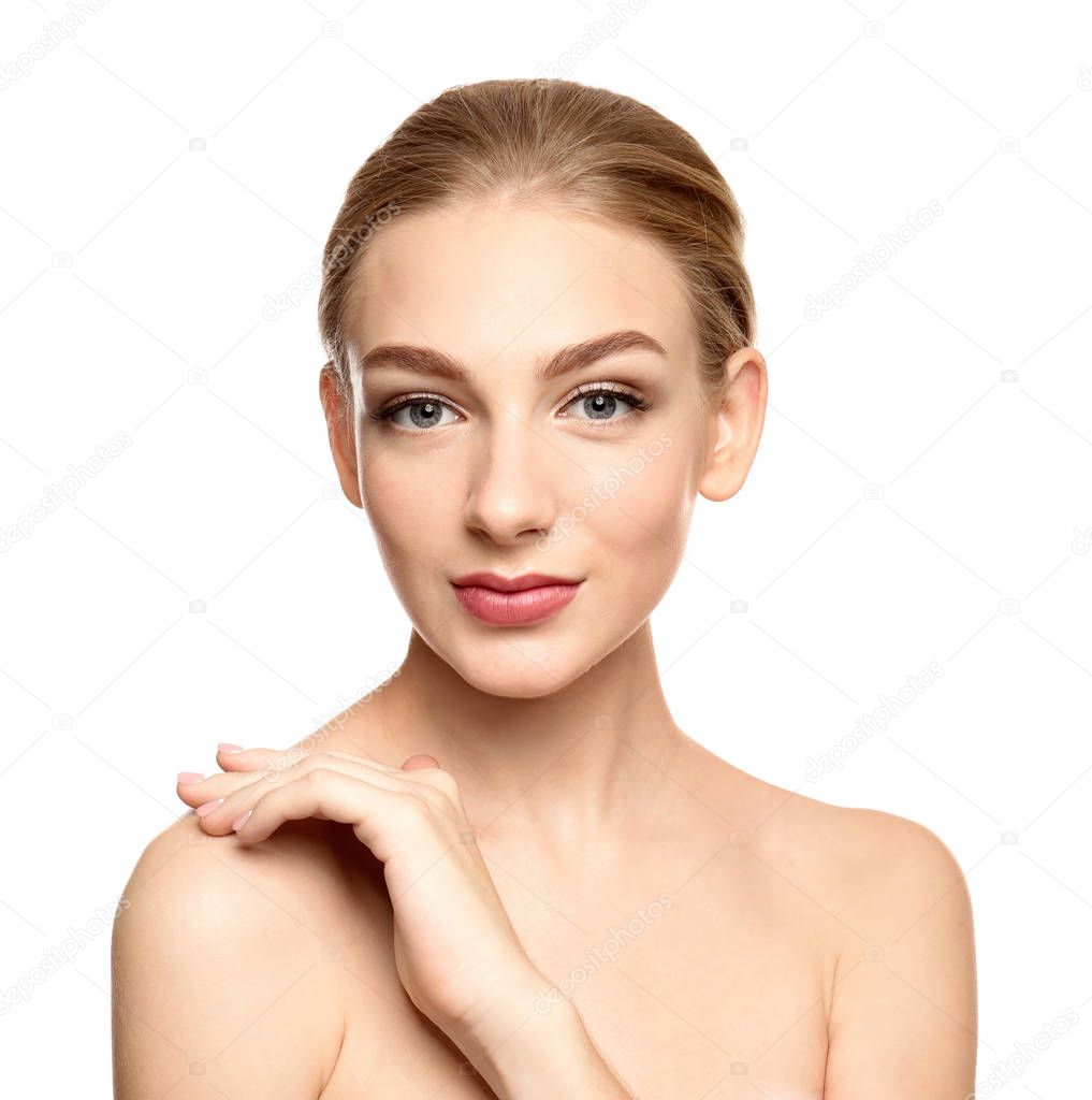 Portrait of beautiful young woman with clear skin on white background