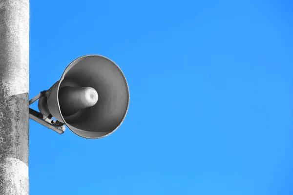 Megaphone on pole outdoors — Stock Photo, Image